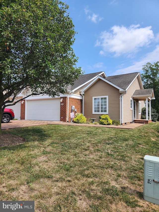 view of front of property featuring a garage and a front lawn