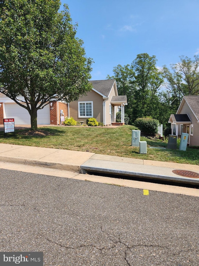 view of front of home featuring a garage and a front yard