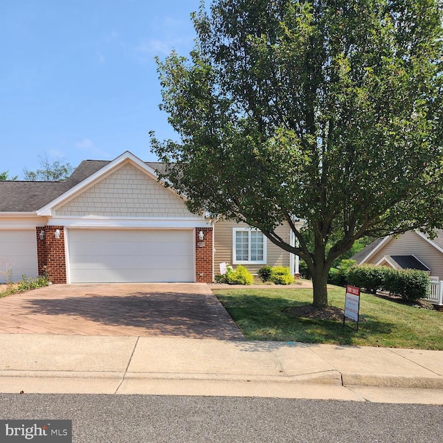 view of front of home featuring a front yard and a garage