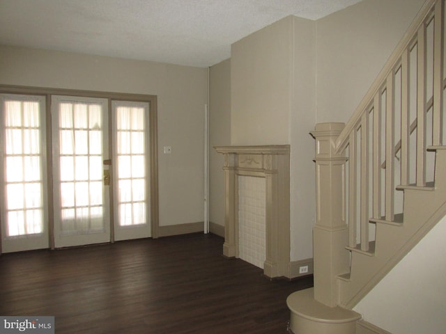 interior space featuring dark hardwood / wood-style flooring and a textured ceiling