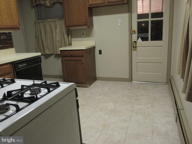 kitchen featuring dishwasher, baseboard heating, and gas range gas stove