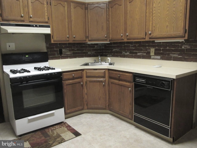 kitchen featuring white range with gas cooktop, black dishwasher, tasteful backsplash, and sink