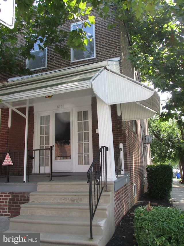 view of front of property with covered porch and brick siding