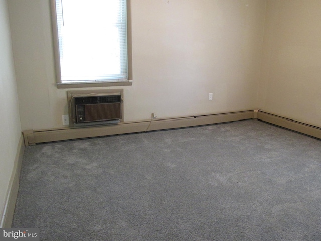 empty room featuring a wall mounted AC and carpet flooring