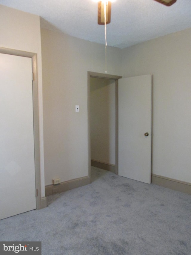 unfurnished bedroom with light colored carpet