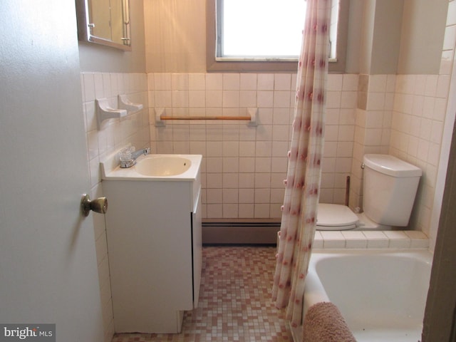 full bathroom with toilet, tile patterned flooring, vanity, baseboard heating, and tile walls