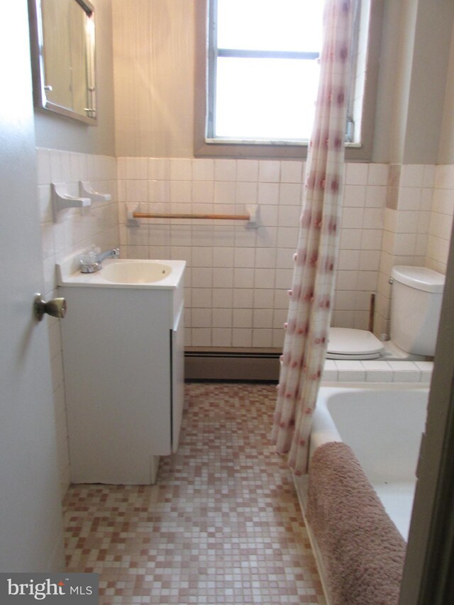 full bathroom with vanity, tile patterned flooring, tile walls, toilet, and a baseboard heating unit