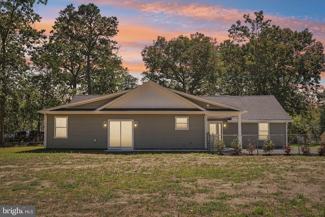 single story home with a lawn