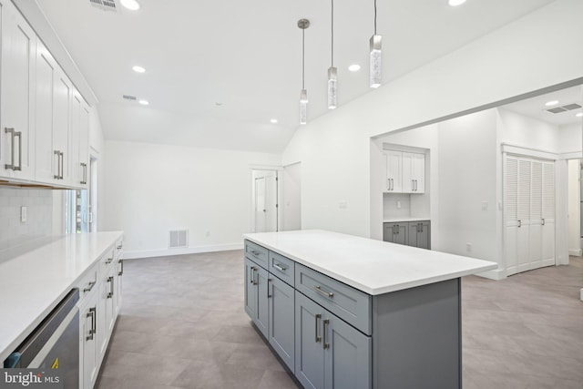 kitchen featuring dishwasher, a kitchen island, white cabinets, and hanging light fixtures