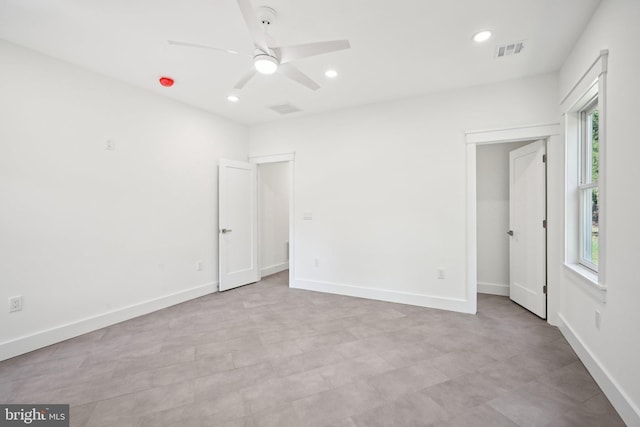 unfurnished bedroom featuring recessed lighting, visible vents, baseboards, and multiple windows