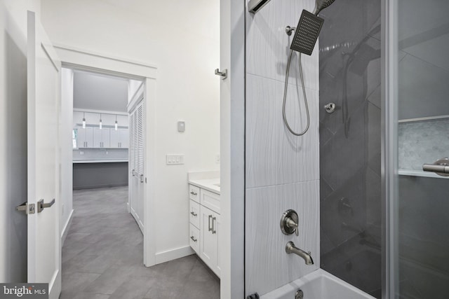 bathroom featuring baseboards, bathing tub / shower combination, and vanity