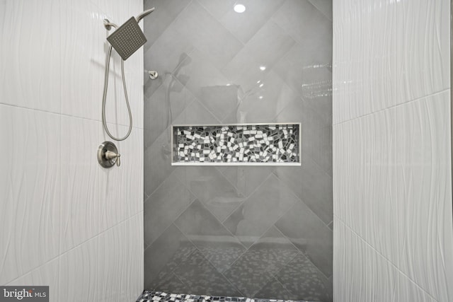 bathroom with a tile shower