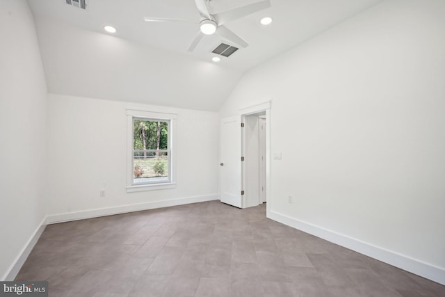 empty room with ceiling fan and vaulted ceiling