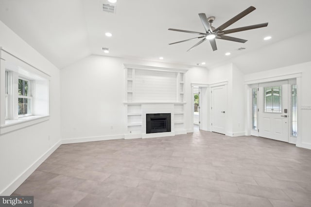 unfurnished living room featuring a large fireplace, ceiling fan, and vaulted ceiling