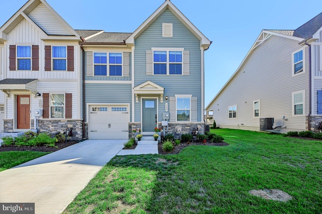 view of front of house with cooling unit, a garage, and a front lawn