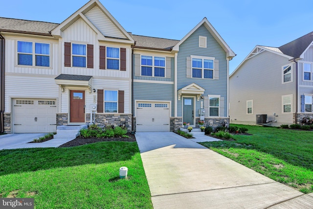 view of front of house with a garage, a front yard, and cooling unit