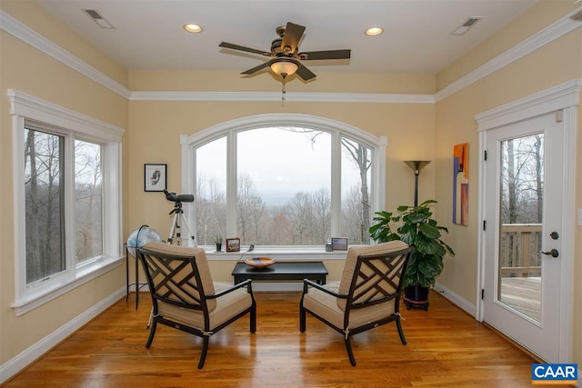 living area with recessed lighting, visible vents, and light wood finished floors