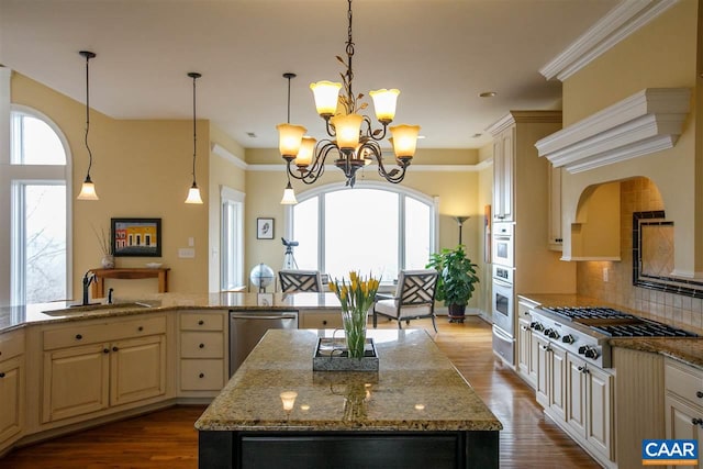 kitchen featuring a sink, appliances with stainless steel finishes, a center island, tasteful backsplash, and dark wood finished floors