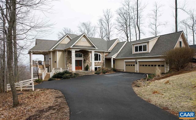 view of front of home featuring a porch and a garage