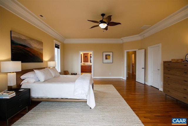 bedroom featuring baseboards, ensuite bath, dark wood finished floors, and crown molding