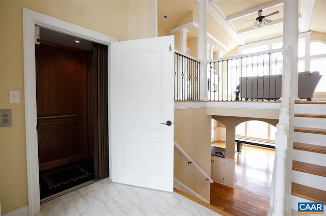 interior space featuring a ceiling fan and marble finish floor