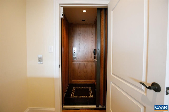 corridor featuring elevator and recessed lighting