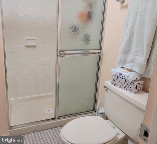 full bathroom with toilet and a stall shower