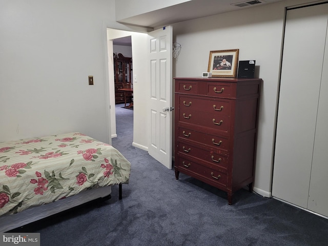 bedroom featuring visible vents and dark colored carpet