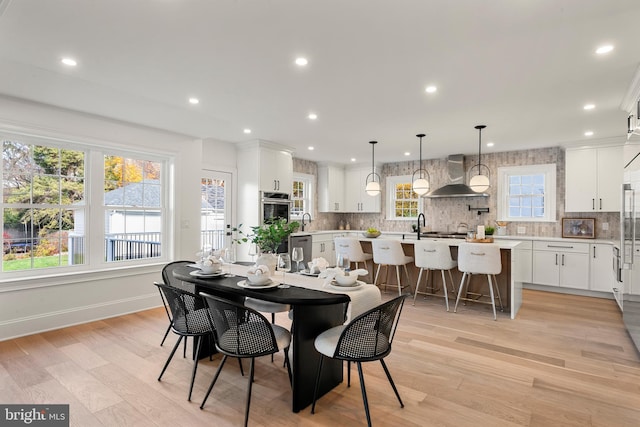 dining room featuring light wood-type flooring and sink