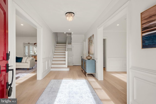 entrance foyer with light wood-type flooring and ornamental molding