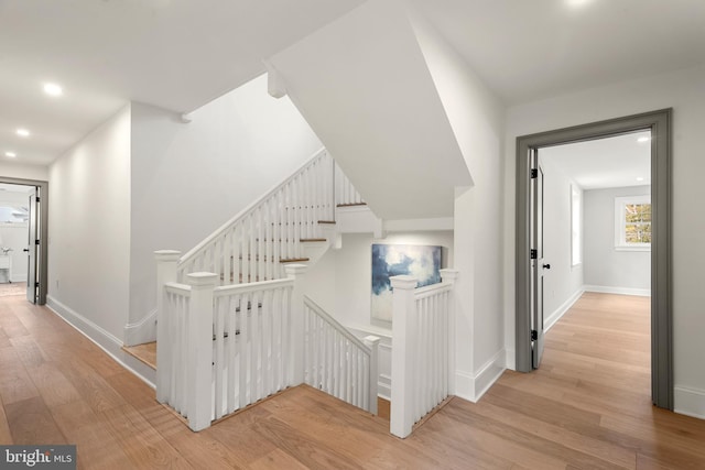 staircase with hardwood / wood-style floors