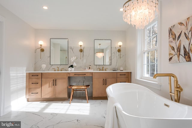 bathroom with vanity, tasteful backsplash, a tub to relax in, and a chandelier