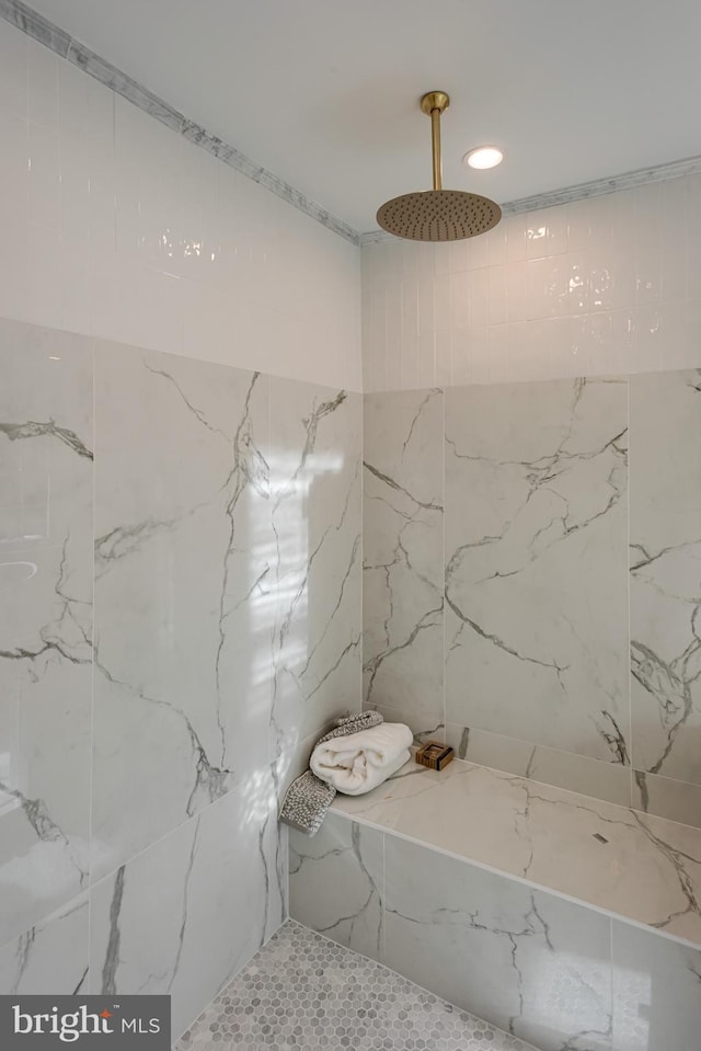 bathroom with a tile shower