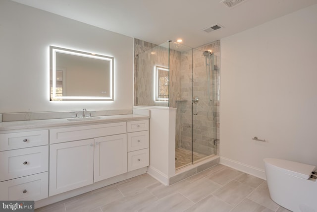 bathroom featuring tile patterned floors, vanity, toilet, and walk in shower