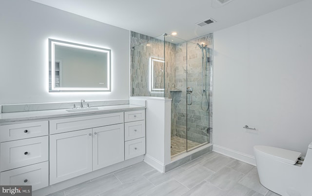 bathroom with vanity, toilet, and a shower with shower door