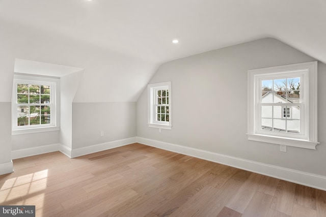 bonus room with light hardwood / wood-style floors and lofted ceiling