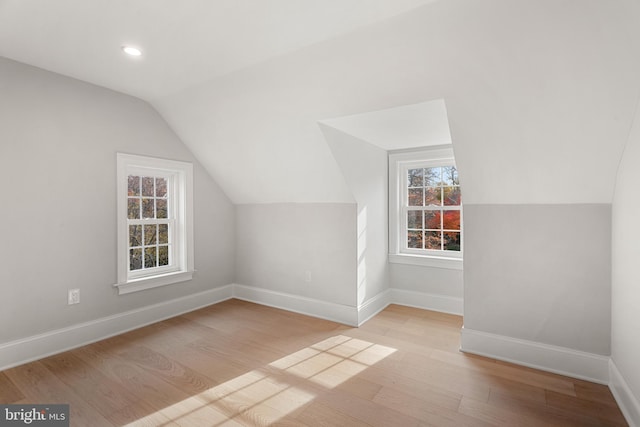 bonus room featuring light hardwood / wood-style flooring and vaulted ceiling