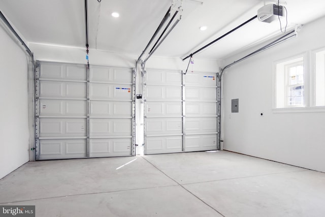 garage featuring electric panel and a garage door opener