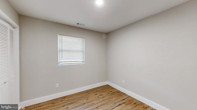 unfurnished bedroom featuring light wood-type flooring and a closet