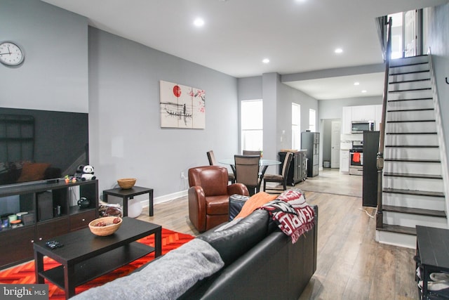 living room featuring light wood-type flooring and a wealth of natural light