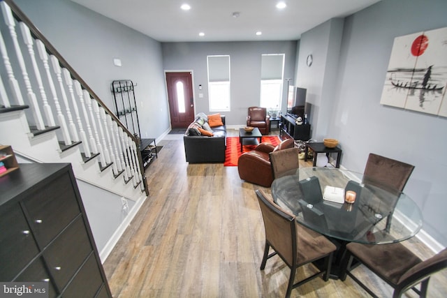 dining space with hardwood / wood-style floors