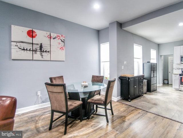 dining room with a healthy amount of sunlight and hardwood / wood-style flooring