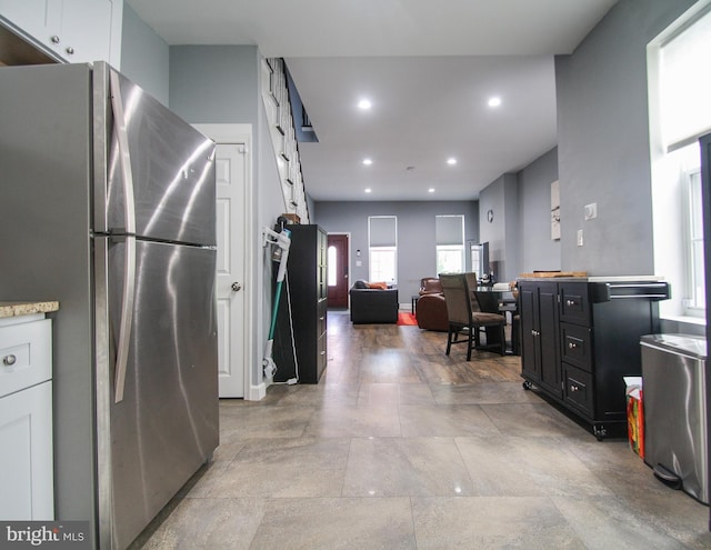 kitchen with white cabinets and stainless steel refrigerator