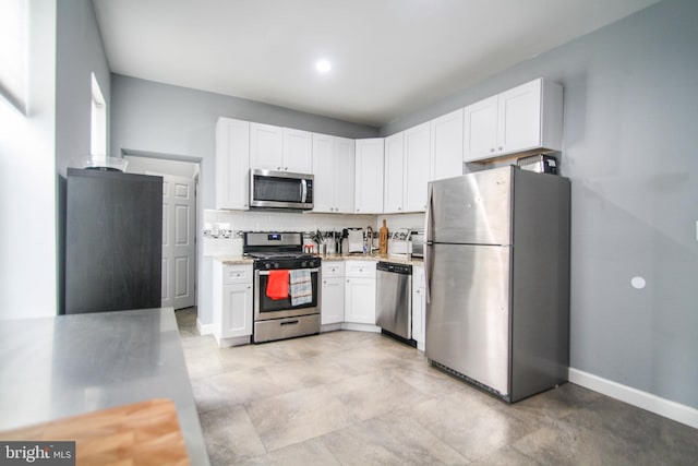 kitchen featuring white cabinetry, appliances with stainless steel finishes, and tasteful backsplash