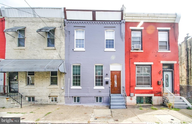 multi unit property featuring entry steps and brick siding