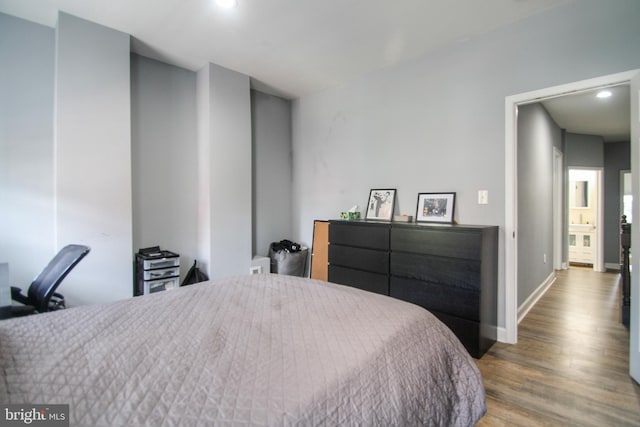 bedroom with hardwood / wood-style flooring