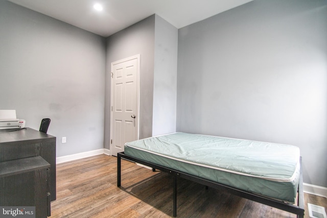 bedroom with wood-type flooring