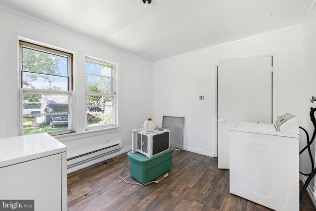 laundry area featuring baseboard heating, dark hardwood / wood-style floors, washer and dryer, and a wealth of natural light