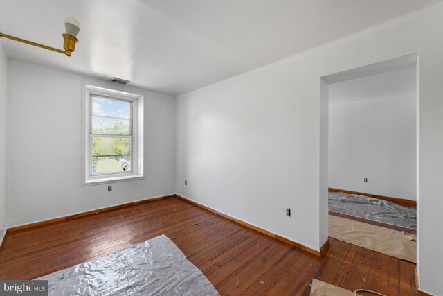 unfurnished room with wood-type flooring