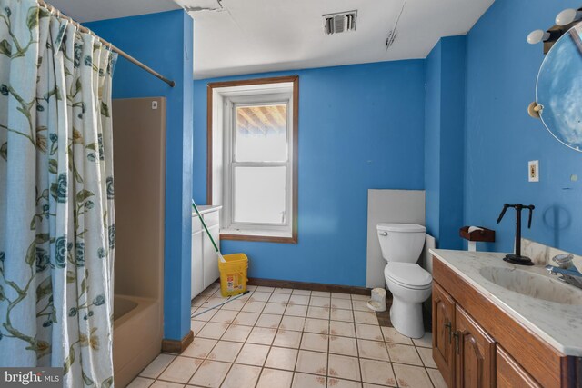 full bathroom featuring vanity, shower / bath combo with shower curtain, and toilet